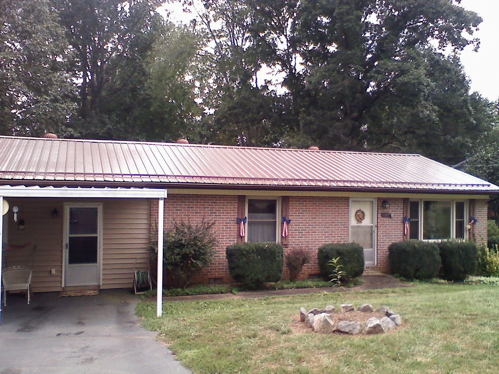 Bronze metal roof and carport on a brick ranch home — Roof Repair work by our crew in Detroit
